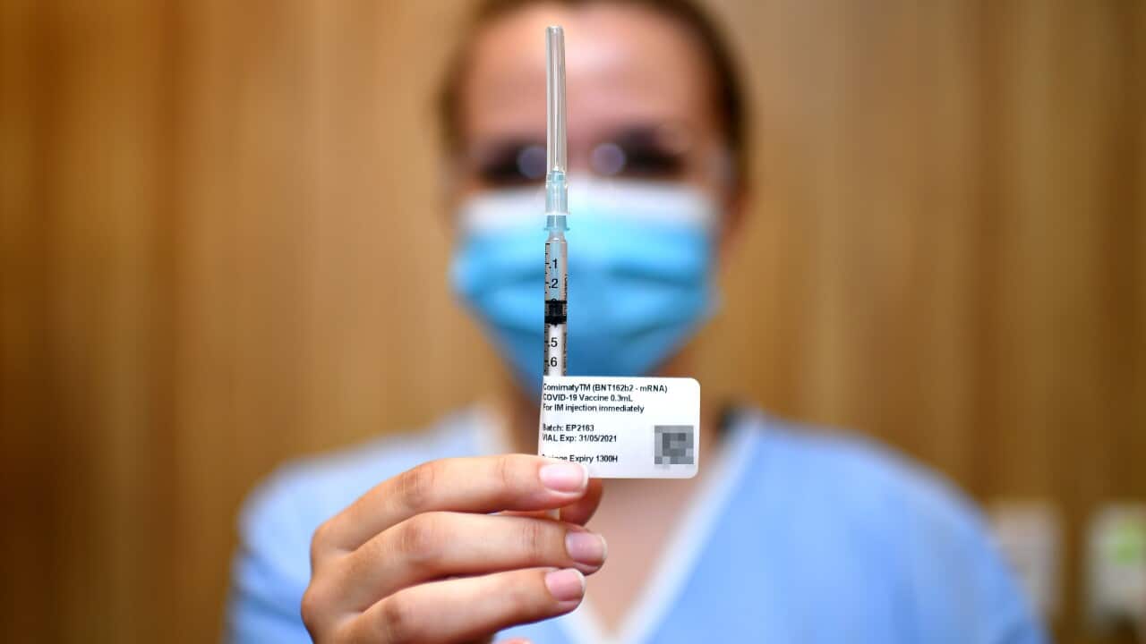 A nurse holds up a syringe containing the COVID-19 Pfizer vaccine at STARS Metro North Health facility, in Brisbane,