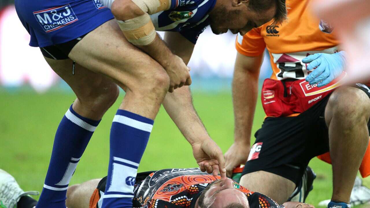 Canterbury's Josh Reynolds checks on an unconscious Robbie Farah