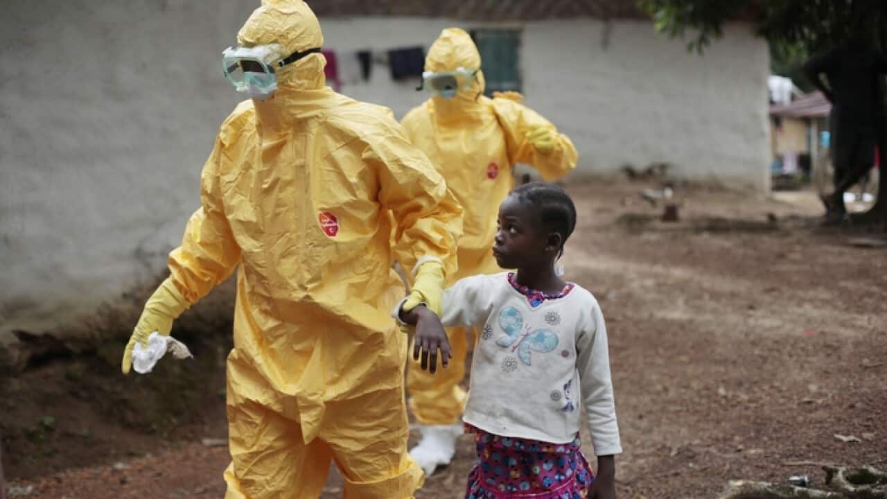 A Liberian child is taken to an ambulance after showing signs of Ebola