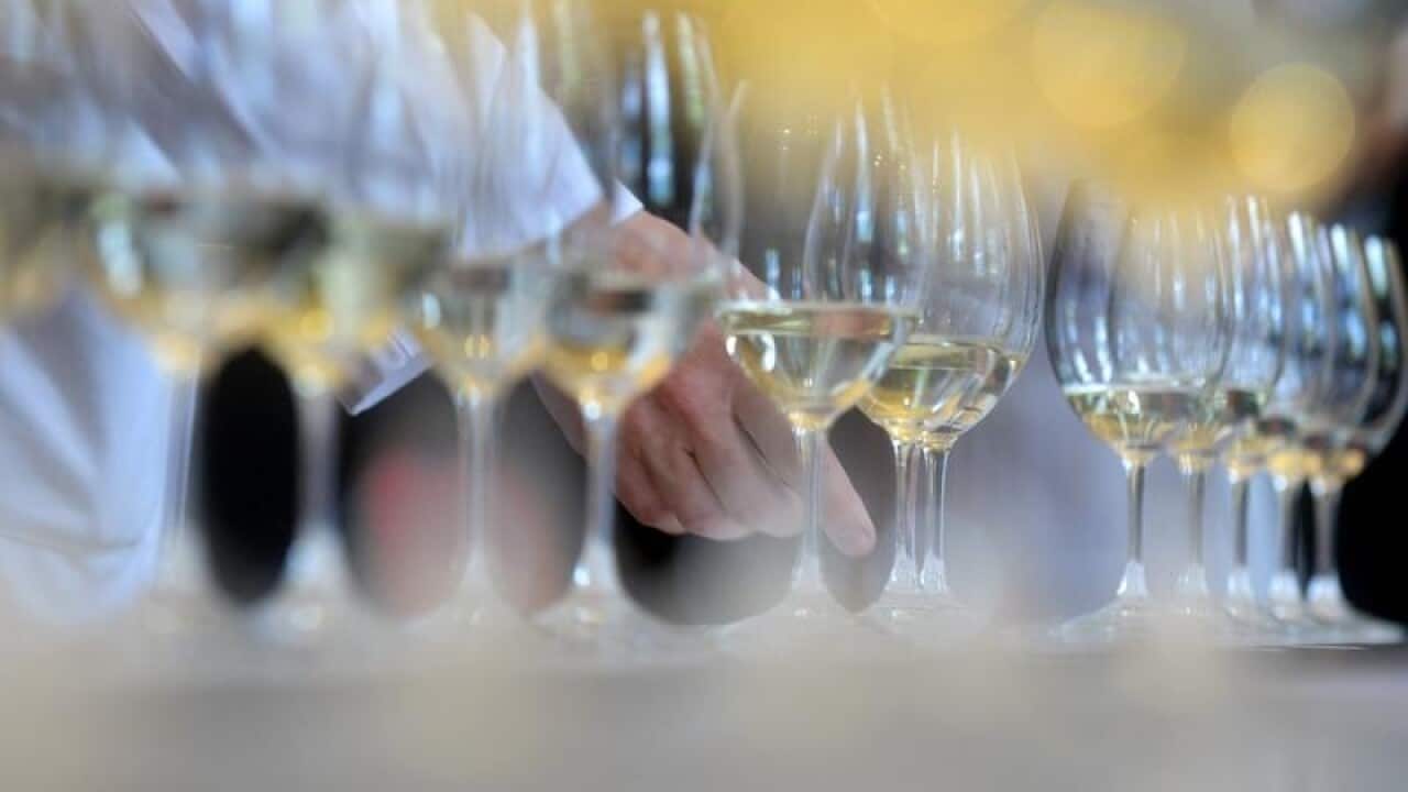 A file image of a wine judge selects a wine