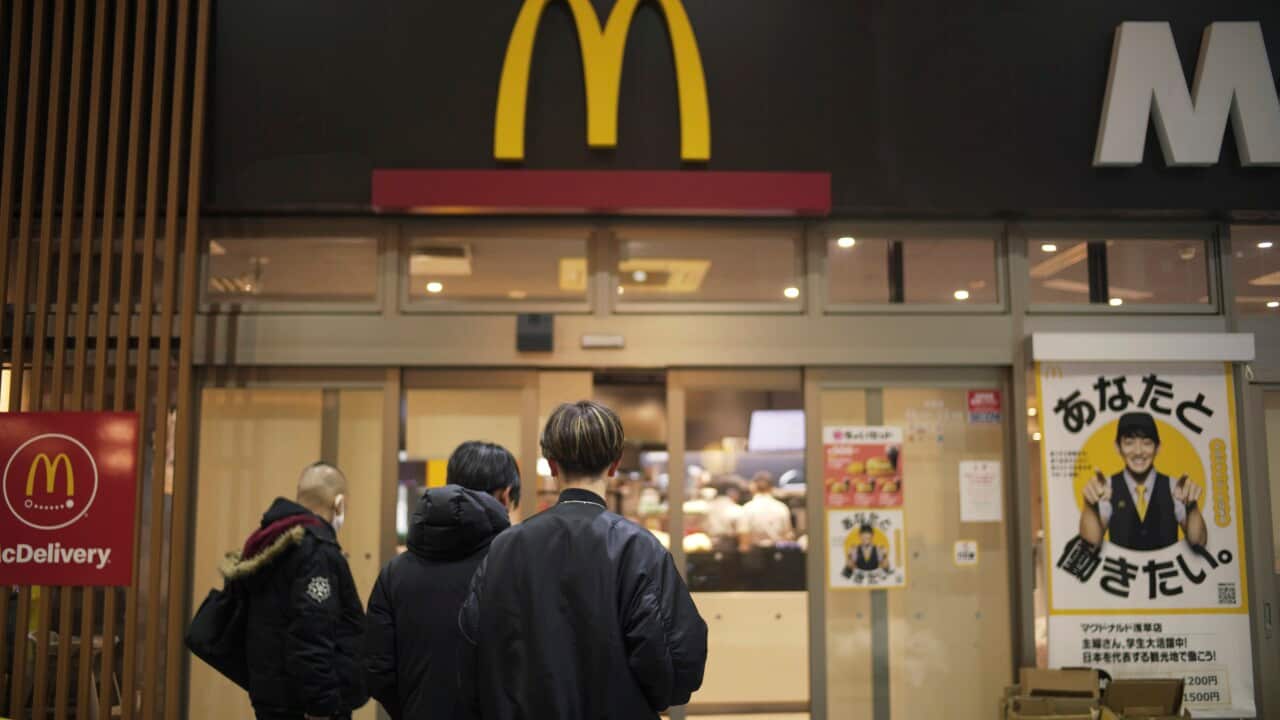 People standing outside a McDonald's in Japan.