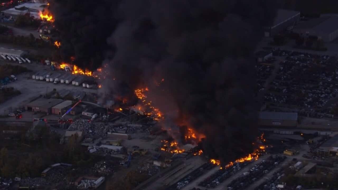 Black smoke billows from a large fire in an industrial area near Louisville airport in Kentucky following a plane crash.