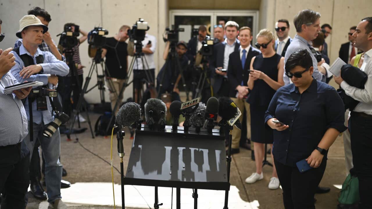 Journalists waiting for a press conference to start