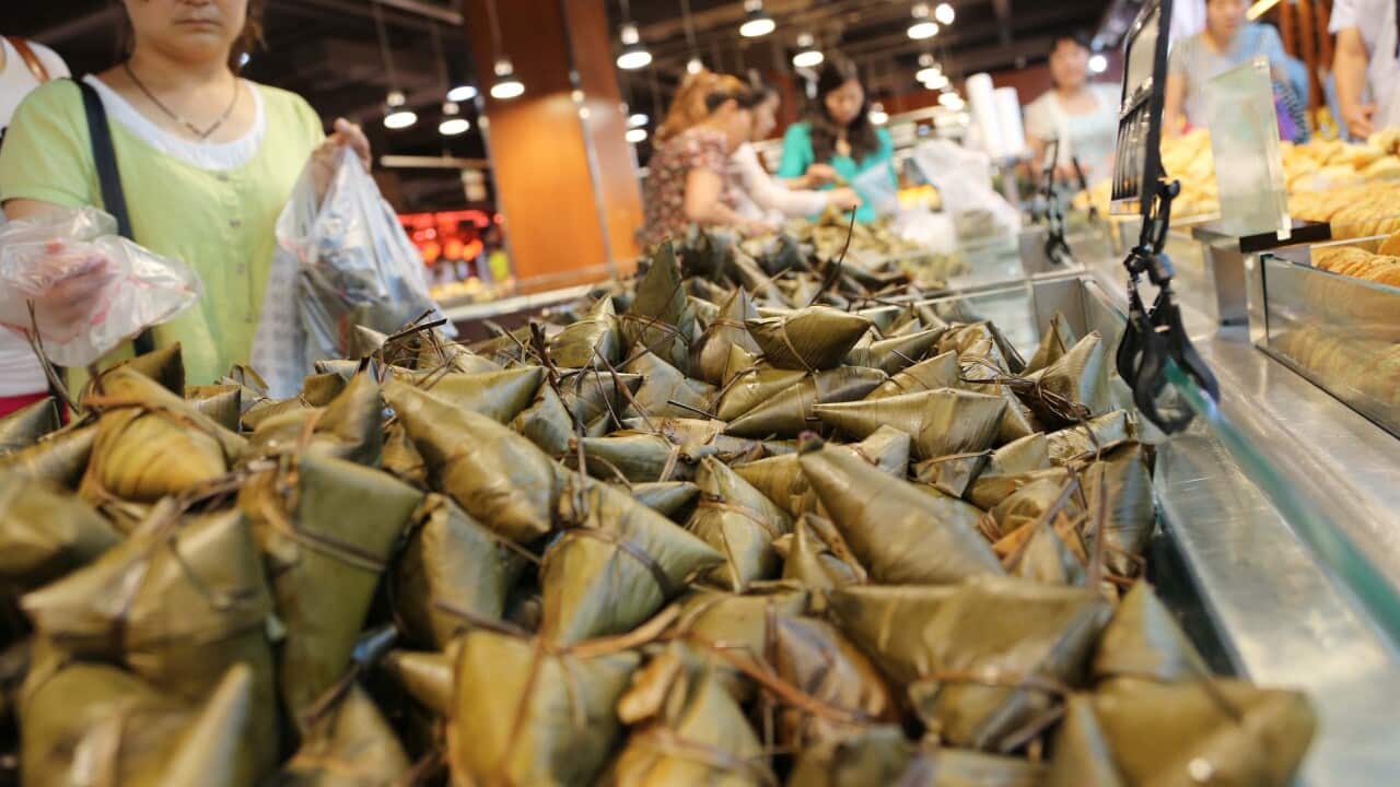 Chinese customers shop for rice dumplings (Zongzi) for the Dragon Boat Festival or Duanwu Festival at a supermarket in Xuchang city, central Chinas Henan province, 25 May 2014.22 countries have banned the traditional Dragon Boat dumplings (zongzi) over fe