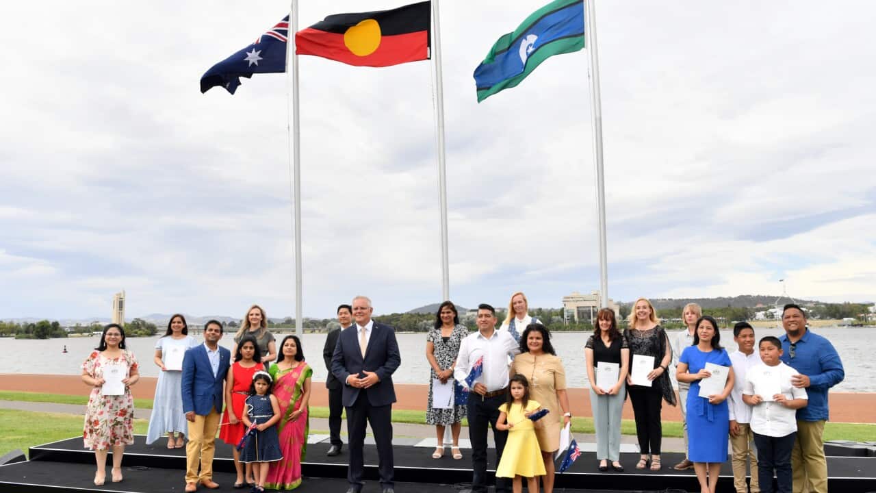 Prime Minister Scott Morrison poses for a photo with new citizens during an Australia Day Citizenship Ceremony and Flag Raising event in Canberra.