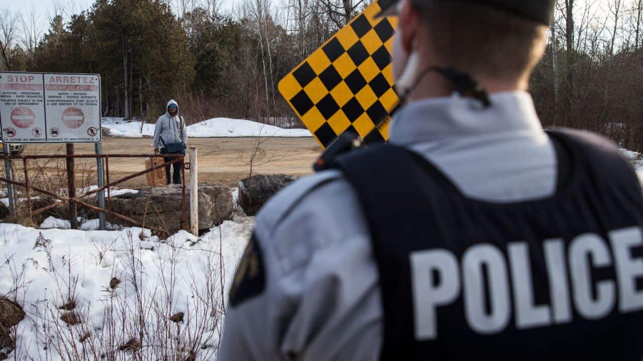 A man claiming to be from Sudan is confronted by a Royal Canadian Mounted Police officer in Hemmingford, Quebec.