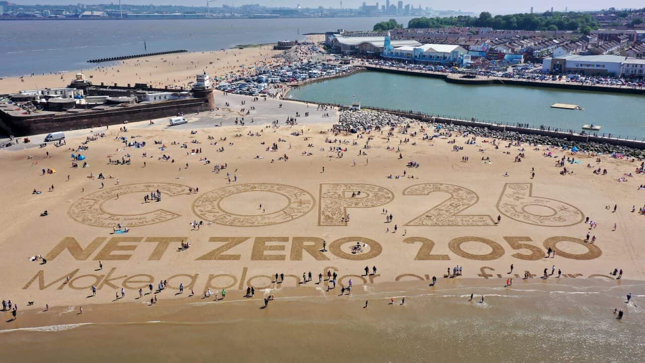 A giant sand art work adorns New Brighton Beach to to highlight global warming and the forthcoming COP26 global climate conference.