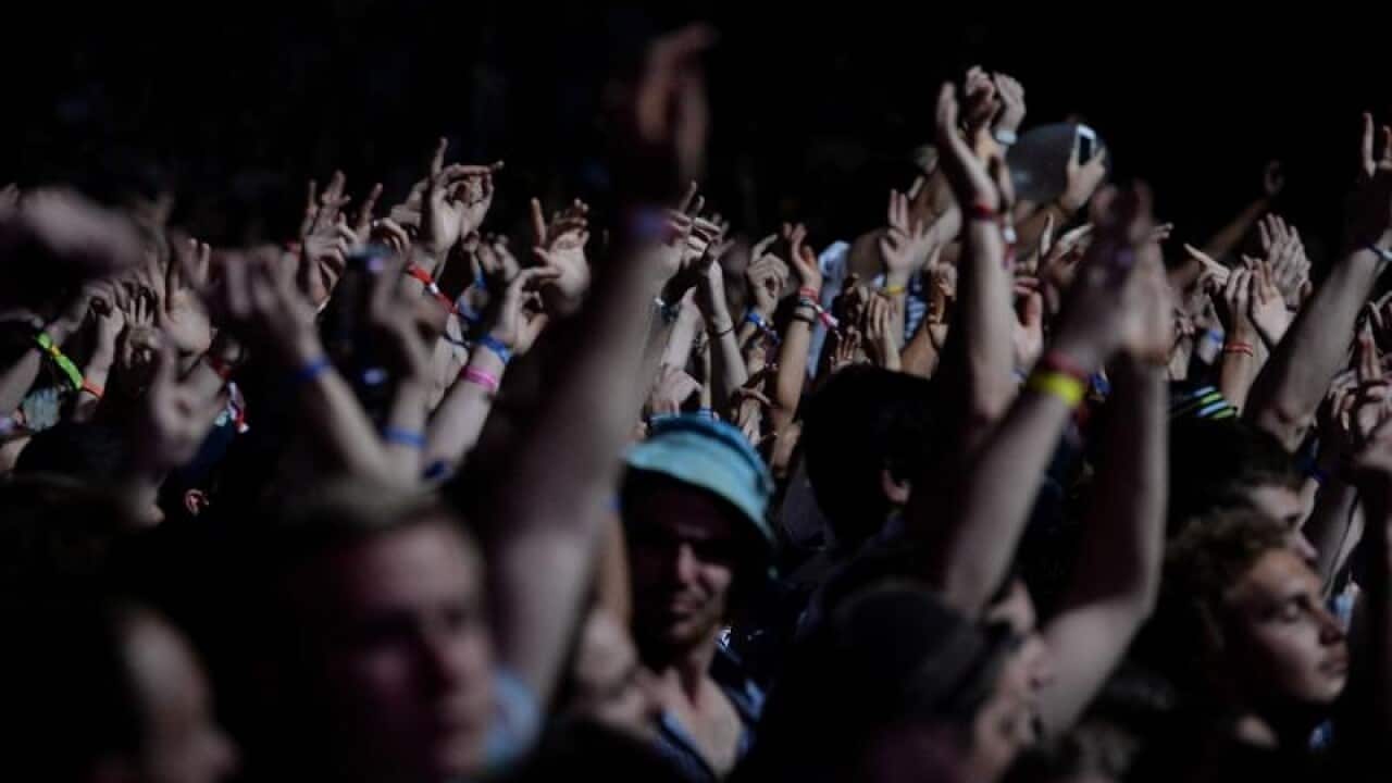 Festival goers dance.