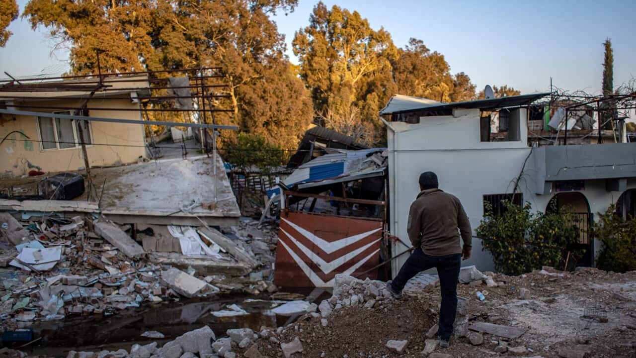 A man looks at a damaged village in Turkiye (AAP).jpg
