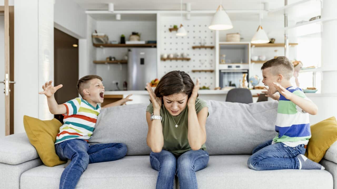 Unhappy mother having problem with noisy naughty two kids