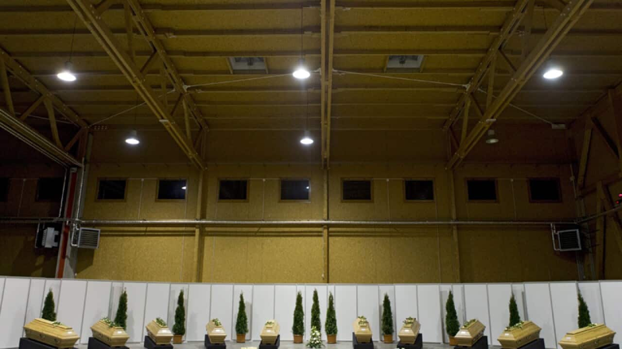Coffins with the remains of victims of 12 January's explosion