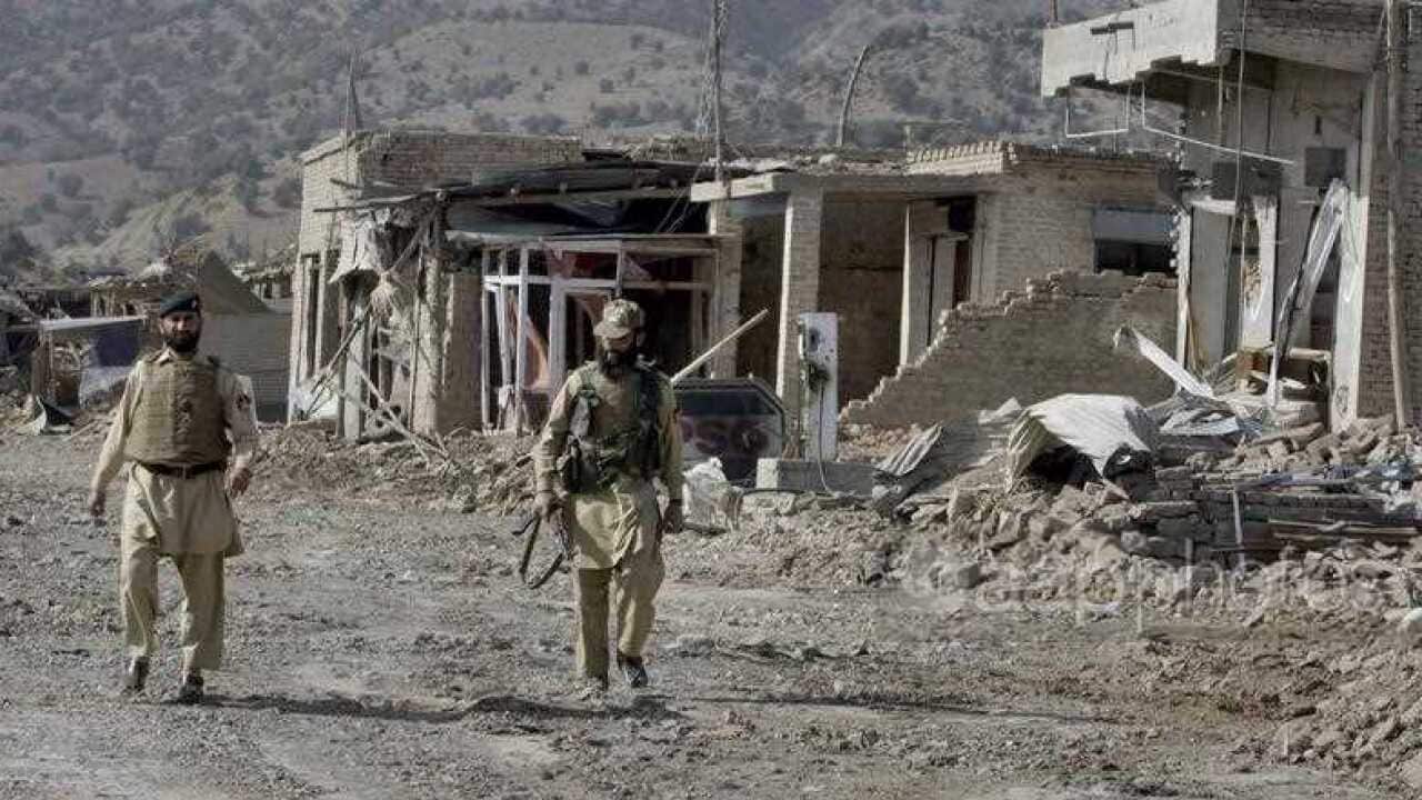 Pakistani troops walk through the damaged market in Sararogha, a town of the troubled Pakistani tribal region of South Waziristan along the Afghan border.
