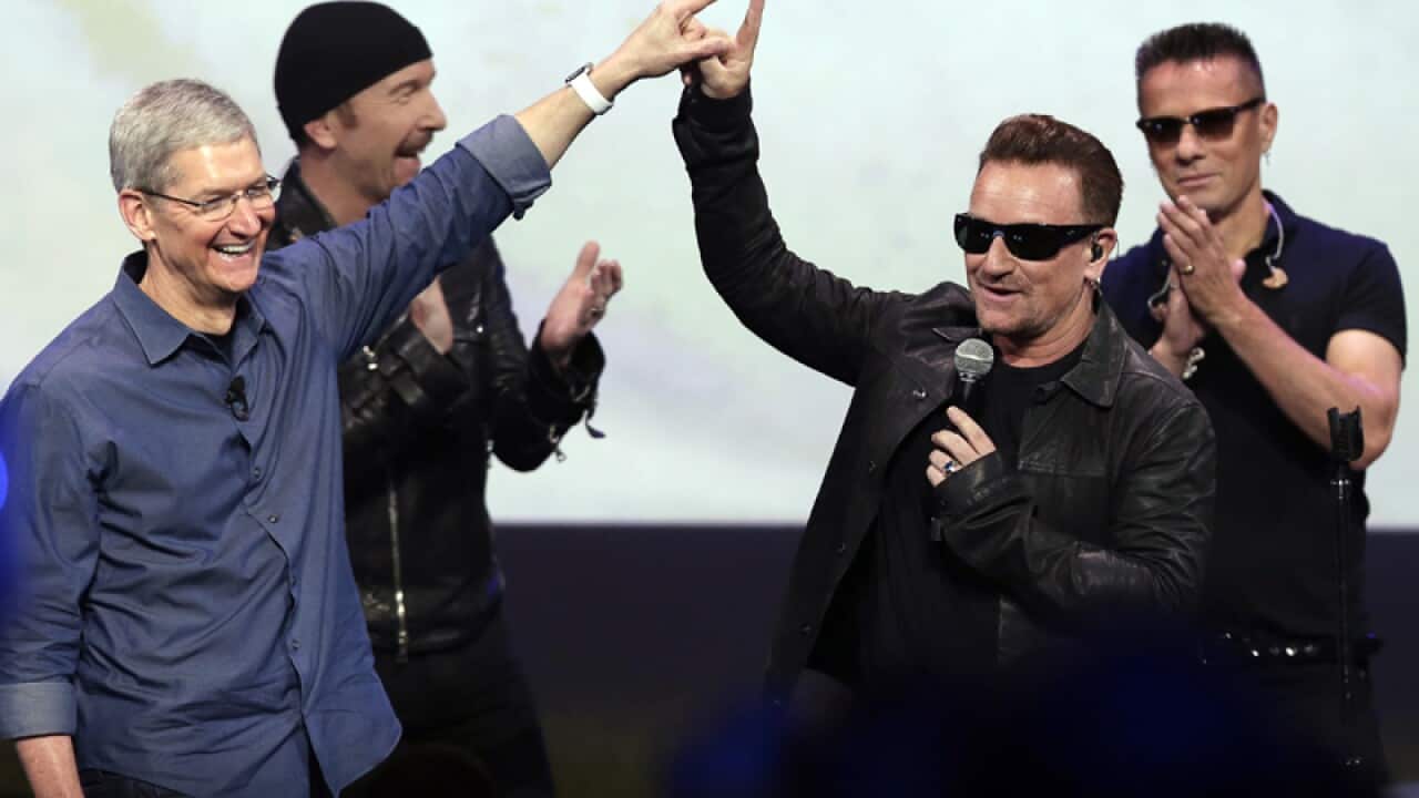 U2 and Apple CEO time cook at an Apple Launch event.