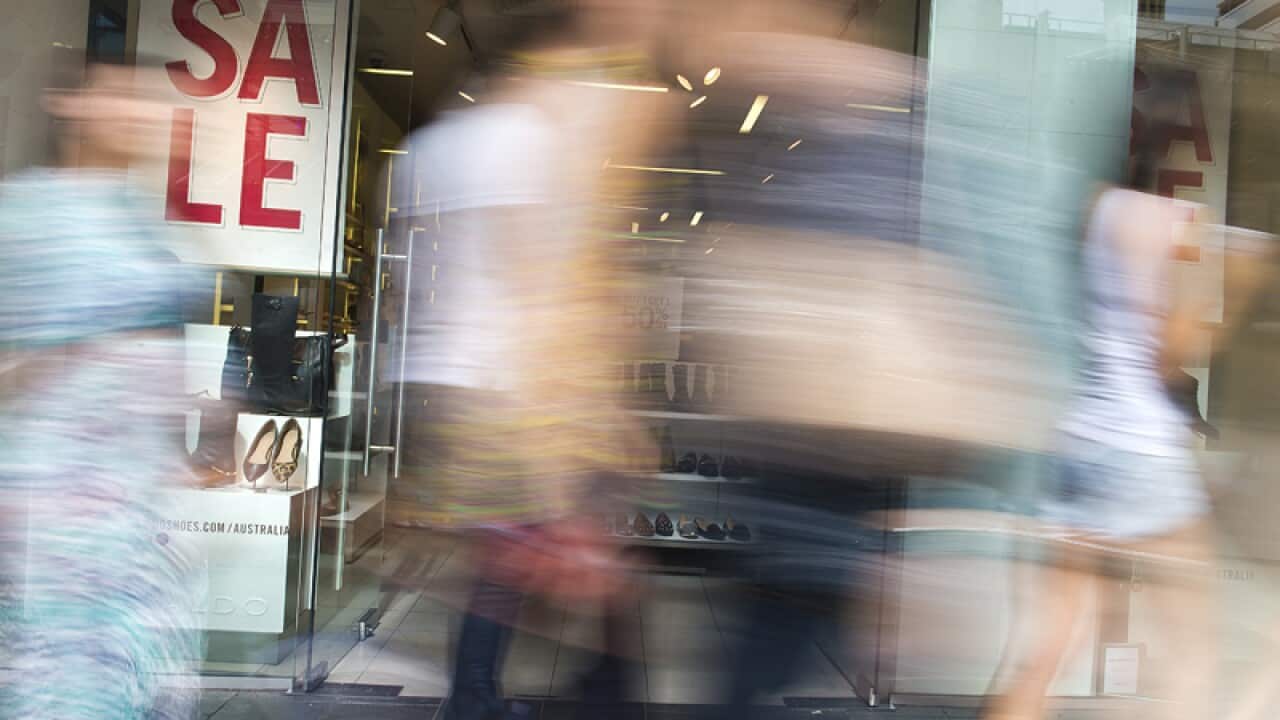 shoppers passing a retail store in the Brisbane