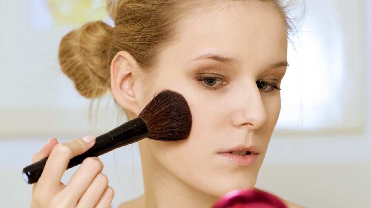 A woman applying make-up