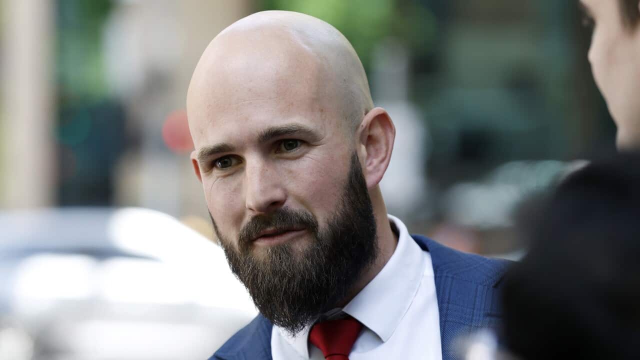 A bald man in a suit.