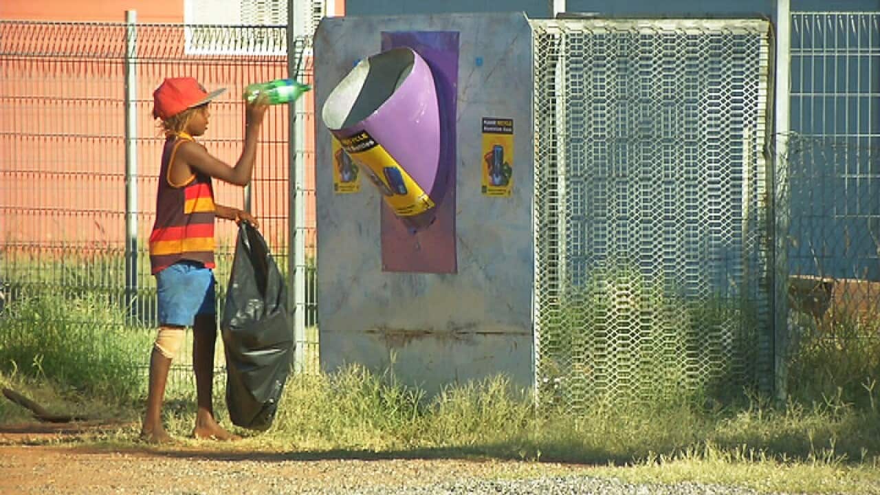 Mount Liebig child picks up rubbish
