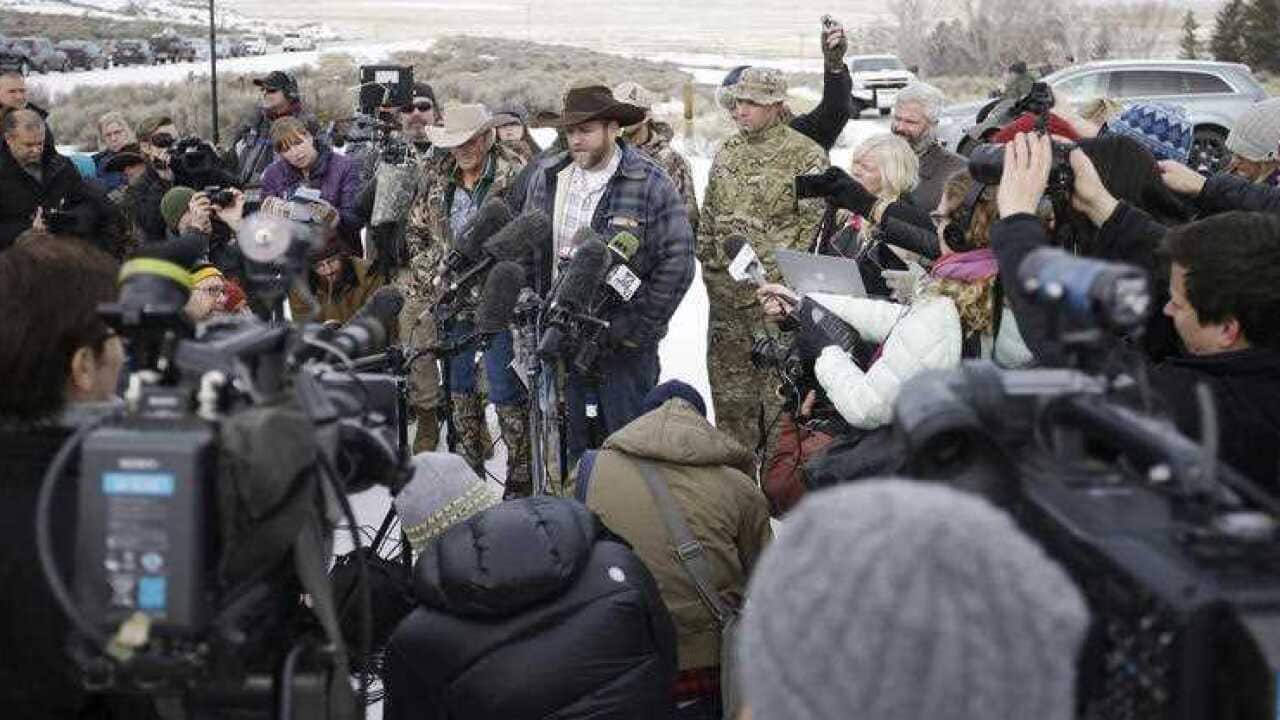 Ammon Bundy, center, one of the sons of Nevada rancher Cliven Bundy, speaks with reporters during a news conference at Malheur National Wildlife Refuge headquarters.