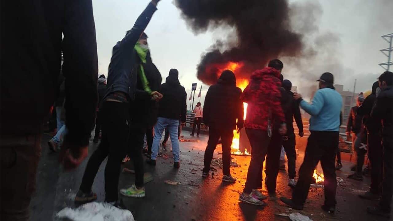 Iranian protesters gather around a fire during a demonstration against an increase in gasoline prices in the capital Tehran, on 16 November, 2019. 