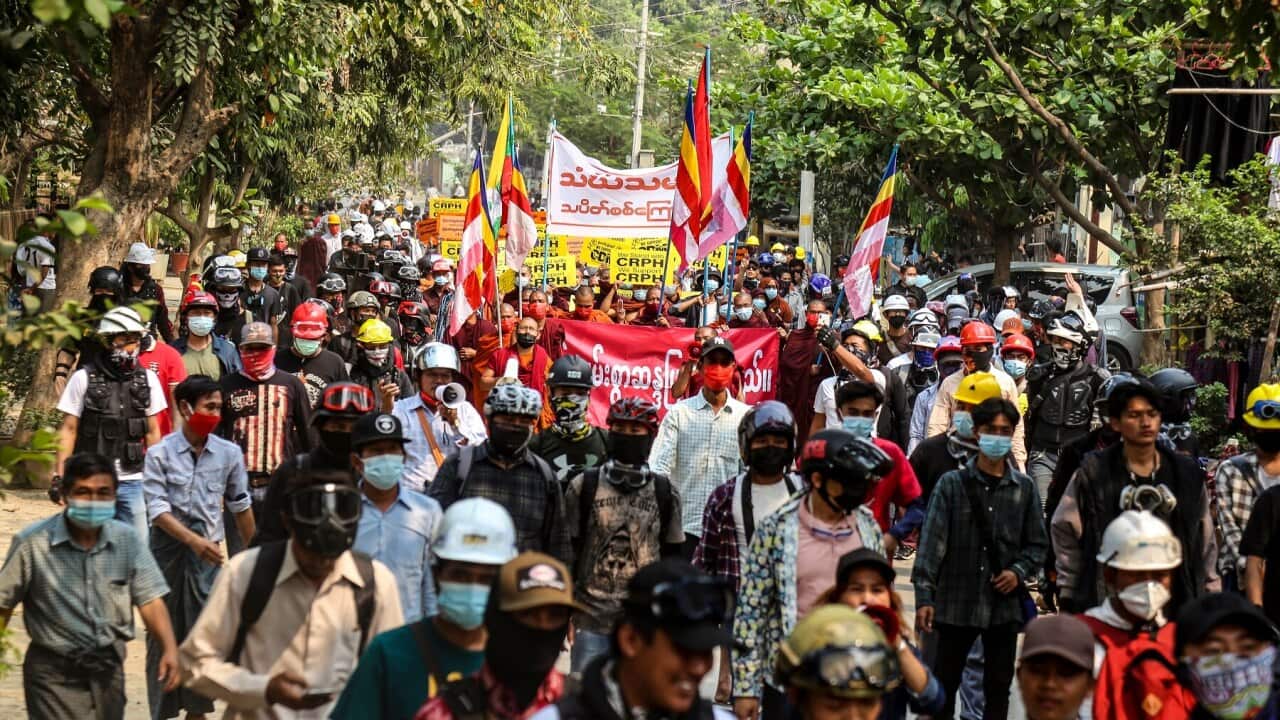 Demonstrators carry placards during a protest against the military coup in Myanmar