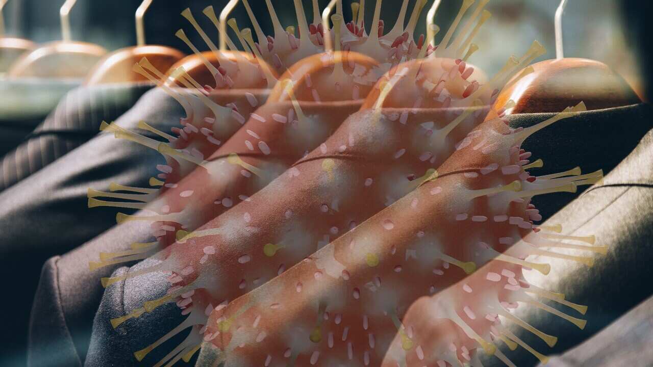 Men's suits hanging in a row on clothing rack