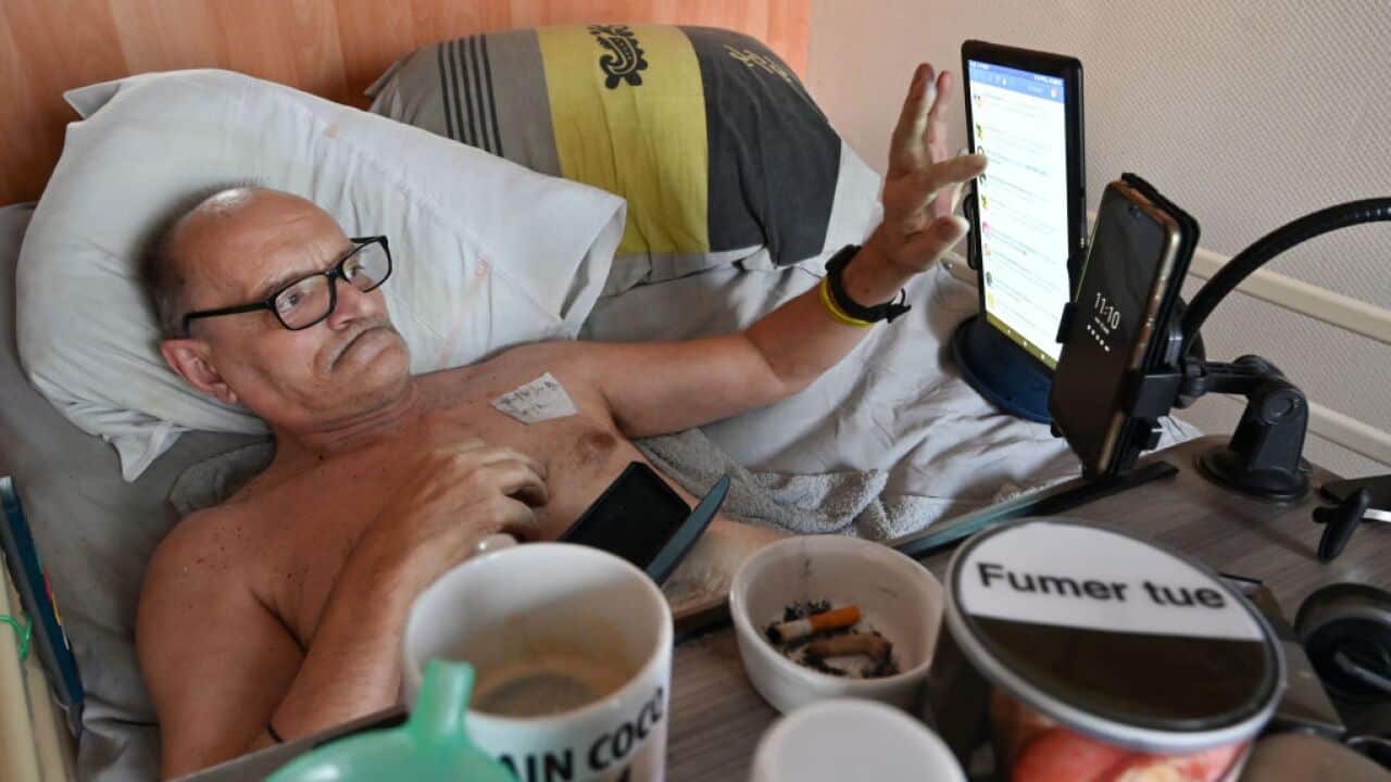 Alain Cocq rests on his medical bed on August 12, 2020 in his flat in Dijon, northeastern France
