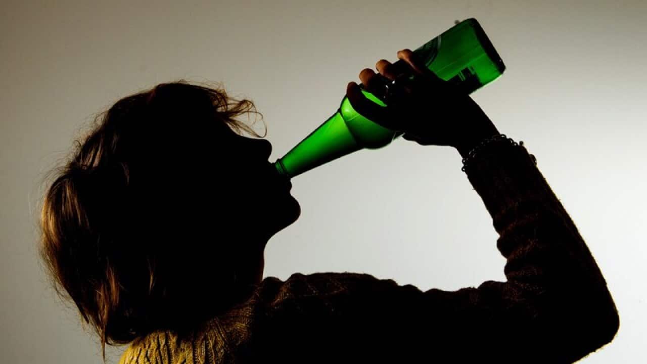 a woman drinking alcohol