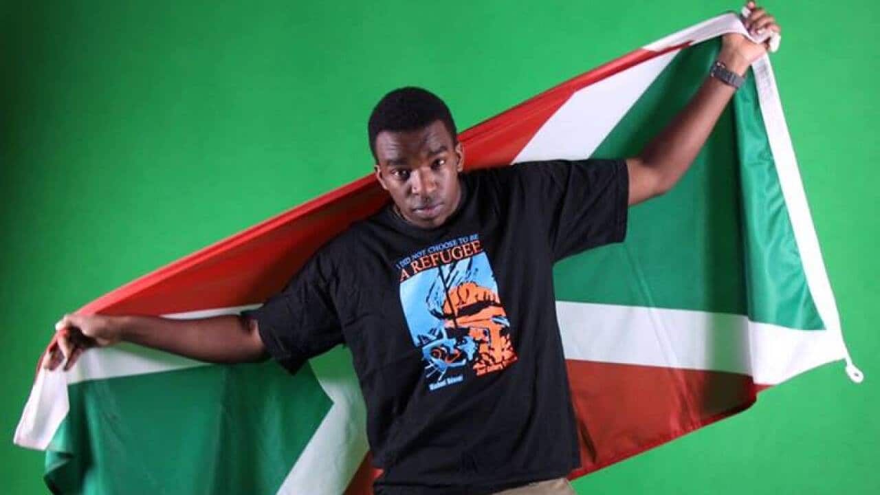 Fablice Manirakiza holding a Burundian flag