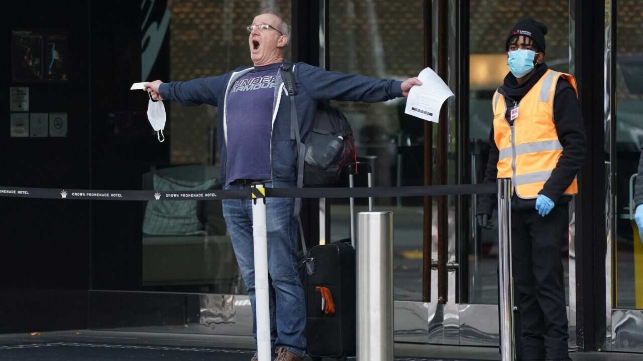 A man reacts as he leaves the Crown Promenade Hotel after spending two weeks in forced quarantine in Melbourne, Sunday, April 12, 2020.