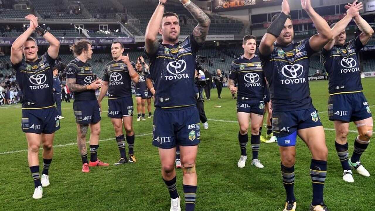 Cowboys players celebrate their win over Cronulla