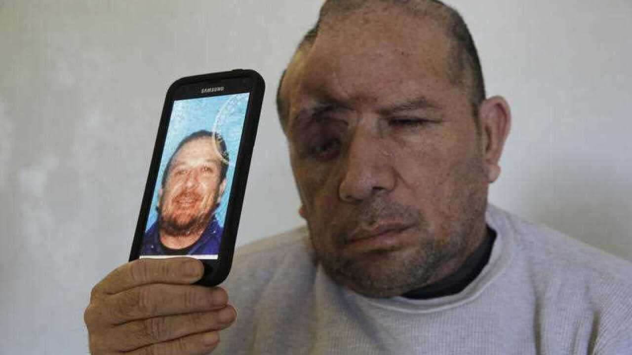 Walter DeLeon poses with a copy of his driver's license photo. (AP)