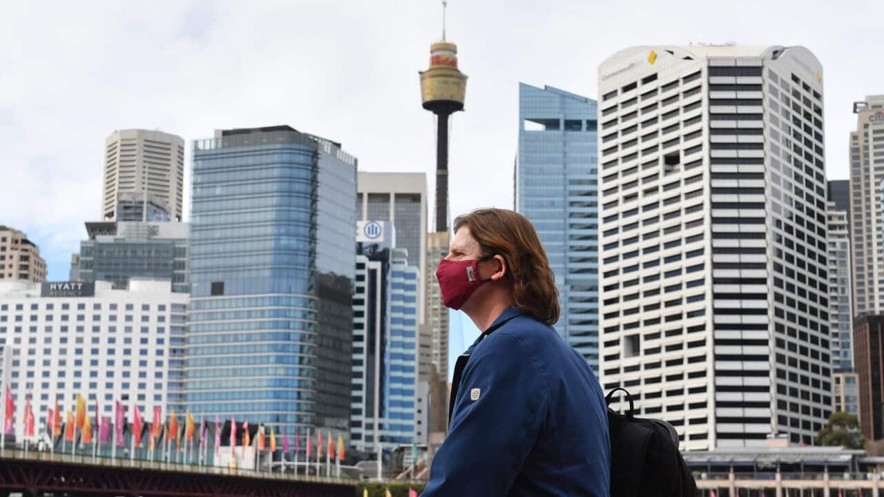 A pedestrian is seen wearing a face mask at Darling Harbour in Sydney.