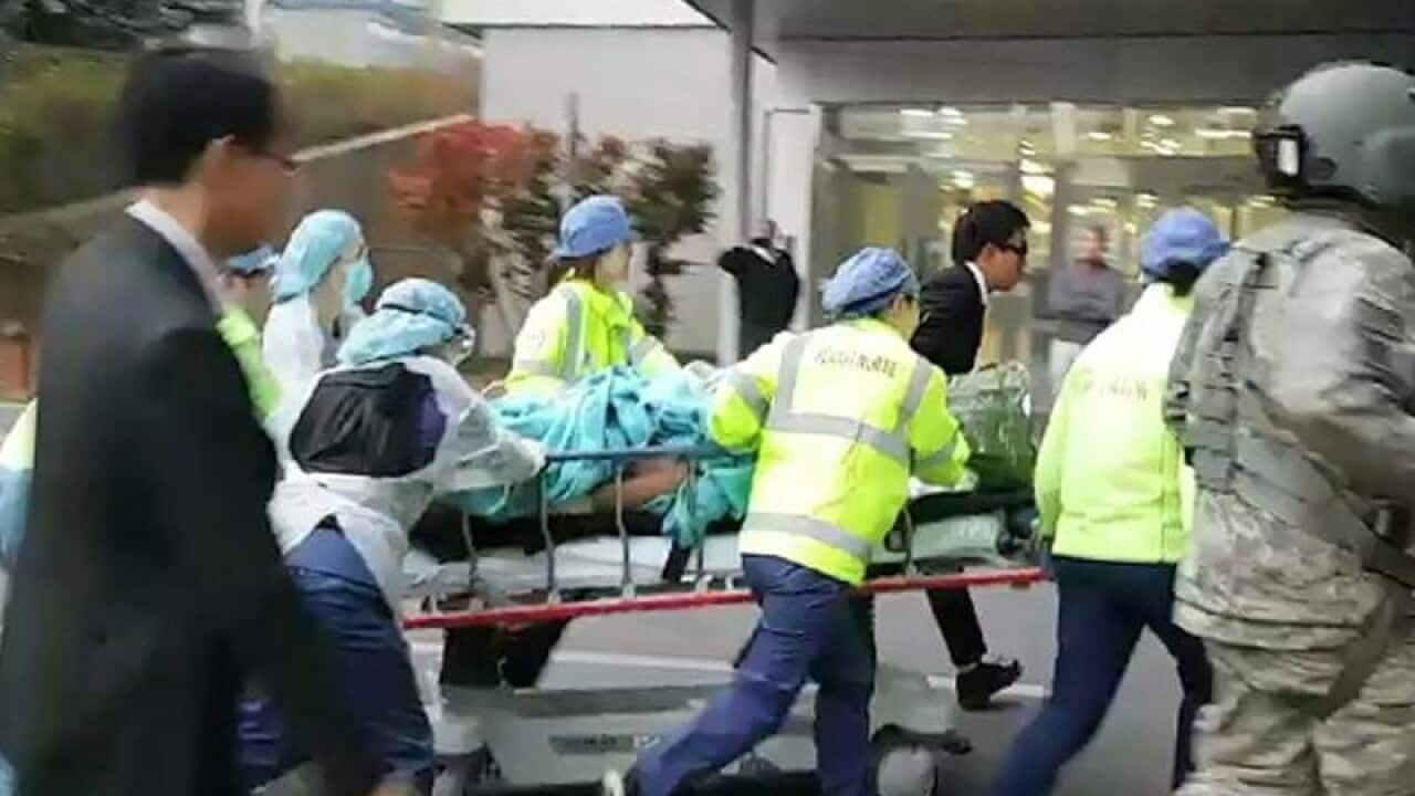 A North Korean soldier is carried into a hospital in Suwon