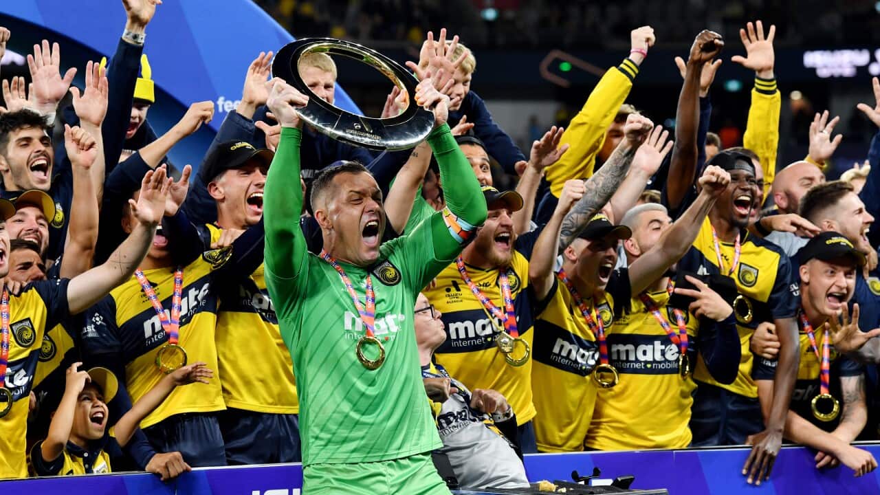 Mariners captain Danny Vukovic lifts the A-League Men's trophy after Central Coast has beaten Melbourne City in the Grand Finals in Sydney