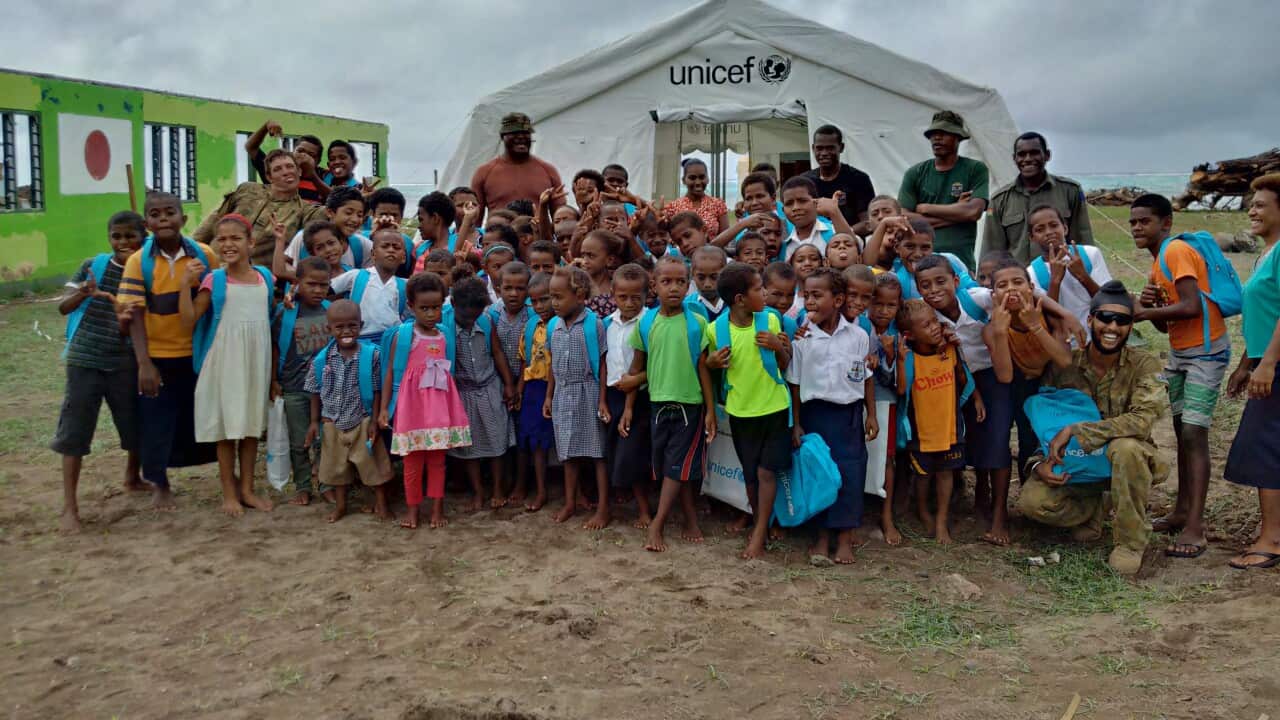 A photo taken during Operation Fiji Assist, alongside the local community that received help from Australian troops