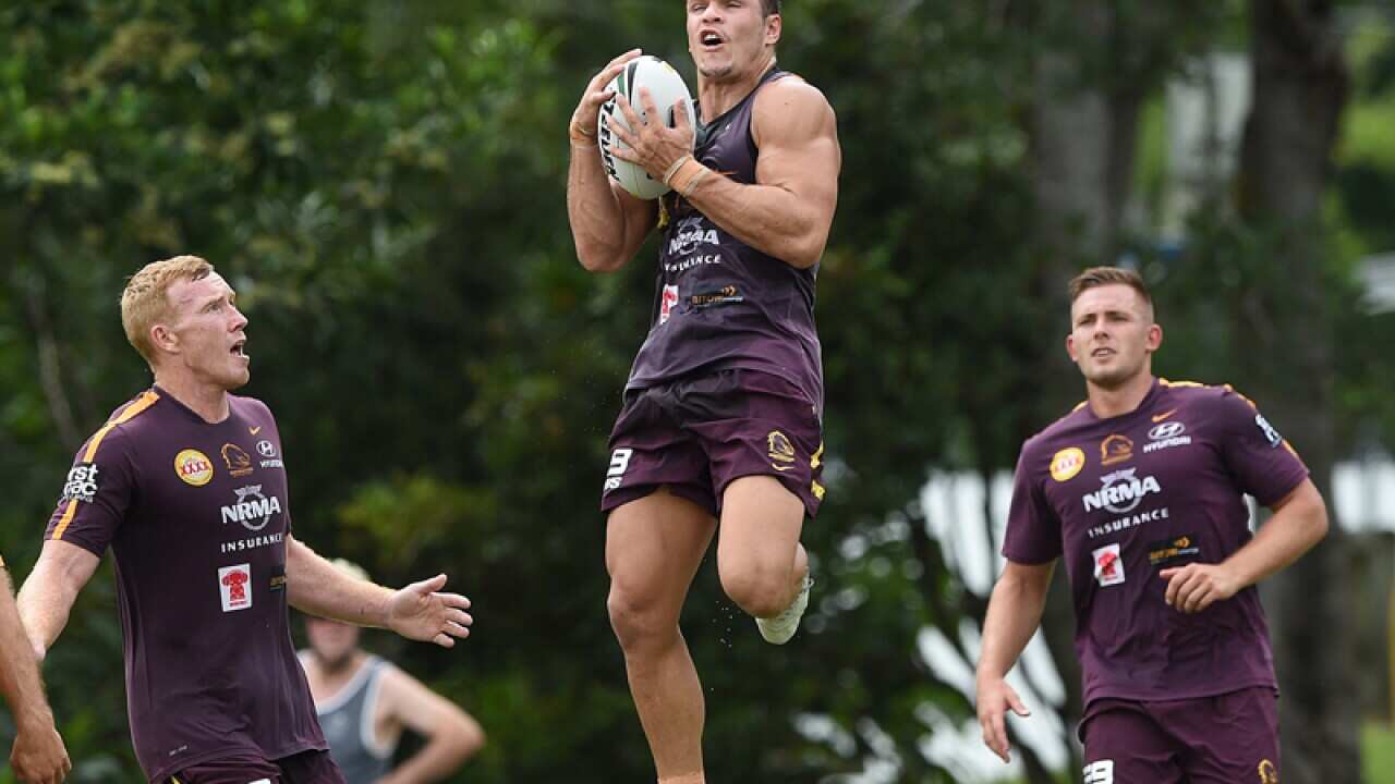 James Roberts (centre) receives the ball