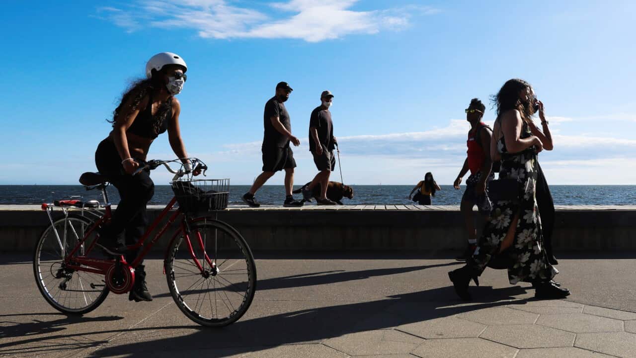 People walking and cycling along the St Kilda Beach Promenade in Melbourne, 28 October, 2020. 