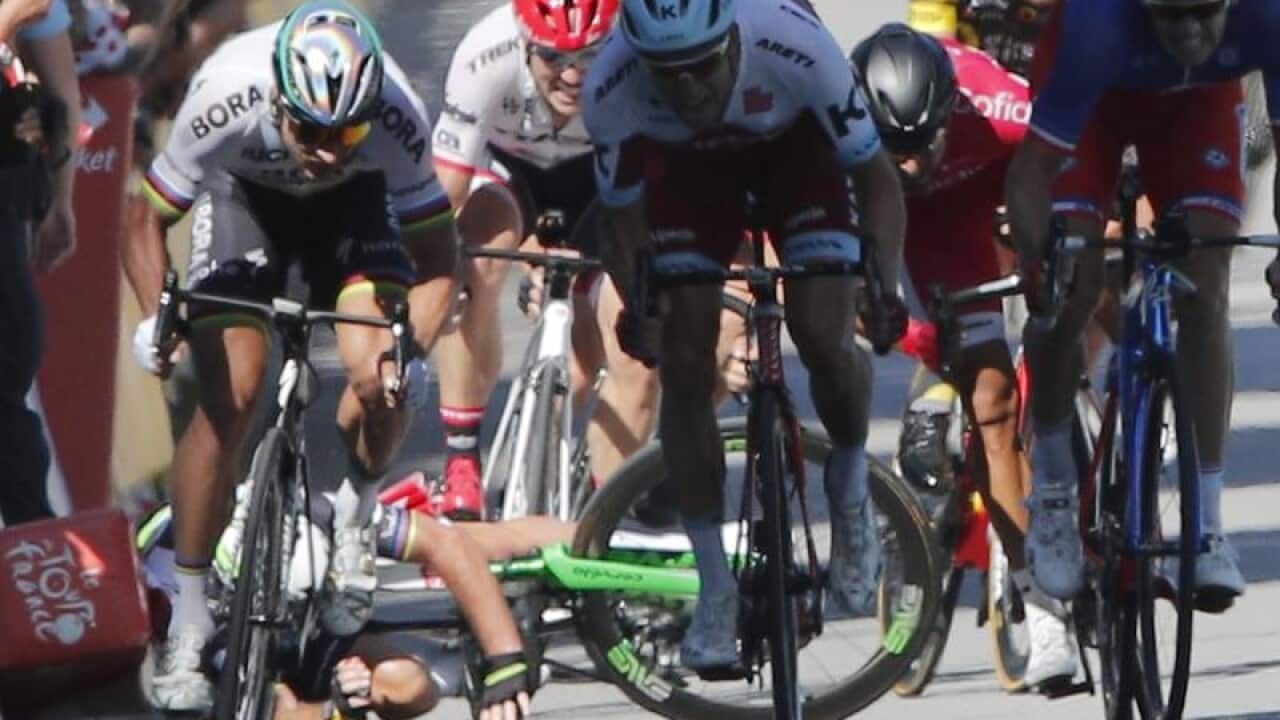 Peter Sagan (far left) sprints as Mark Cavendish crashes
