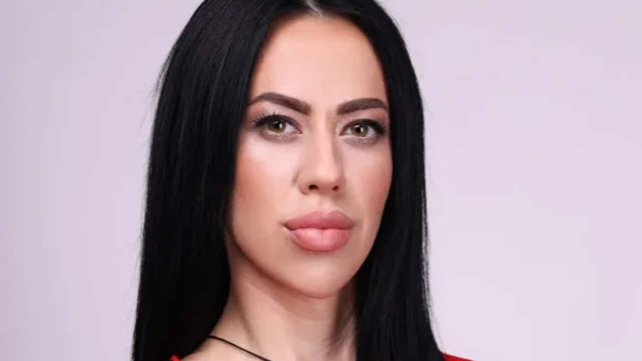 A woman wearing a red top