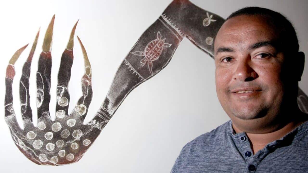 Dennis Nona with artwork.
