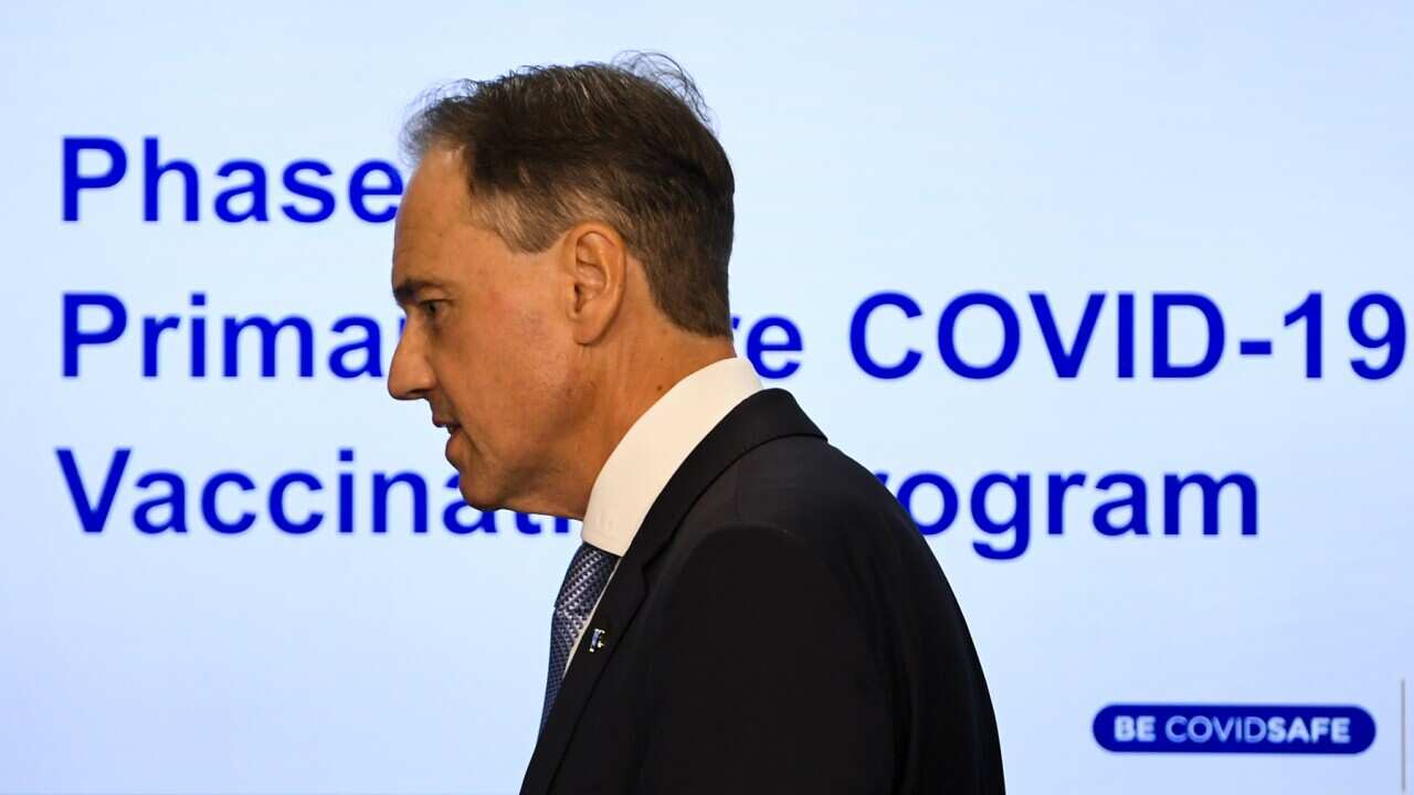 Health Minister Greg Hunt arrives to speak to media