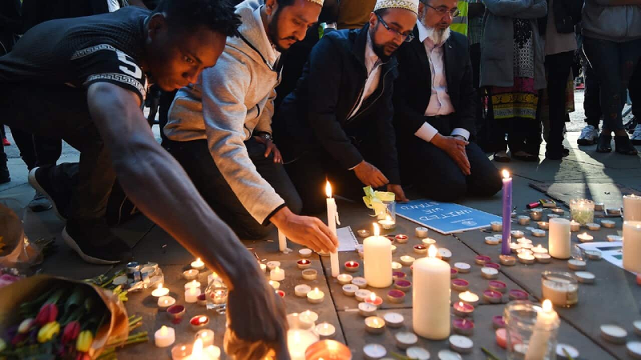 People lay tributes at a vigil for the Manchester attack