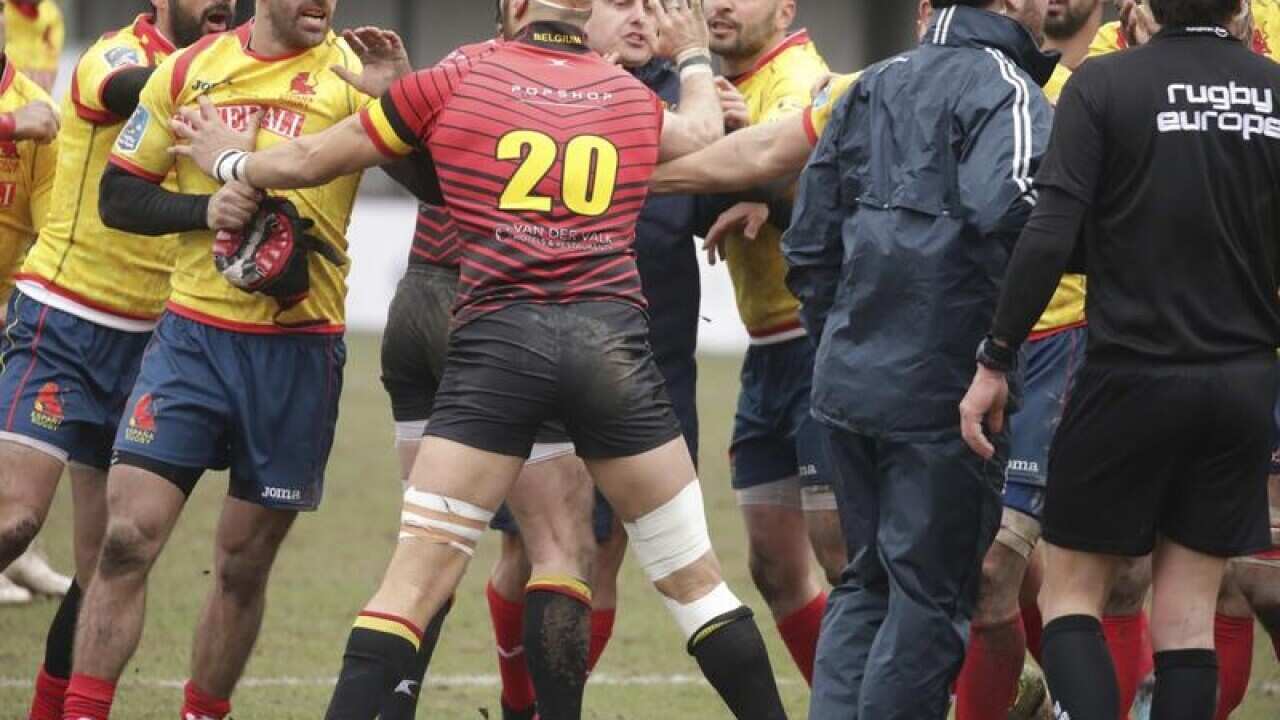 Spain's players, left, clash with Romania referee Vlad Iordachescu.