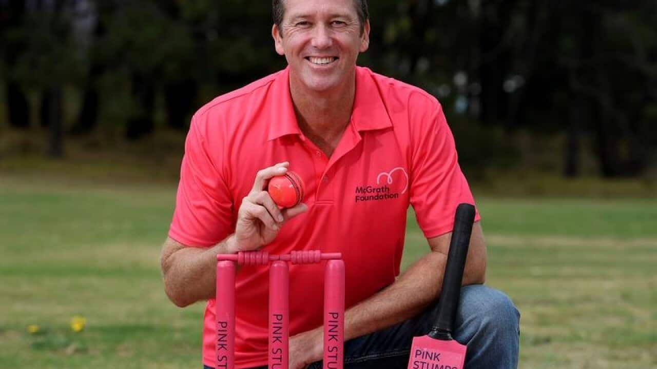 Glenn McGrath poses for a photograph wearing pink.