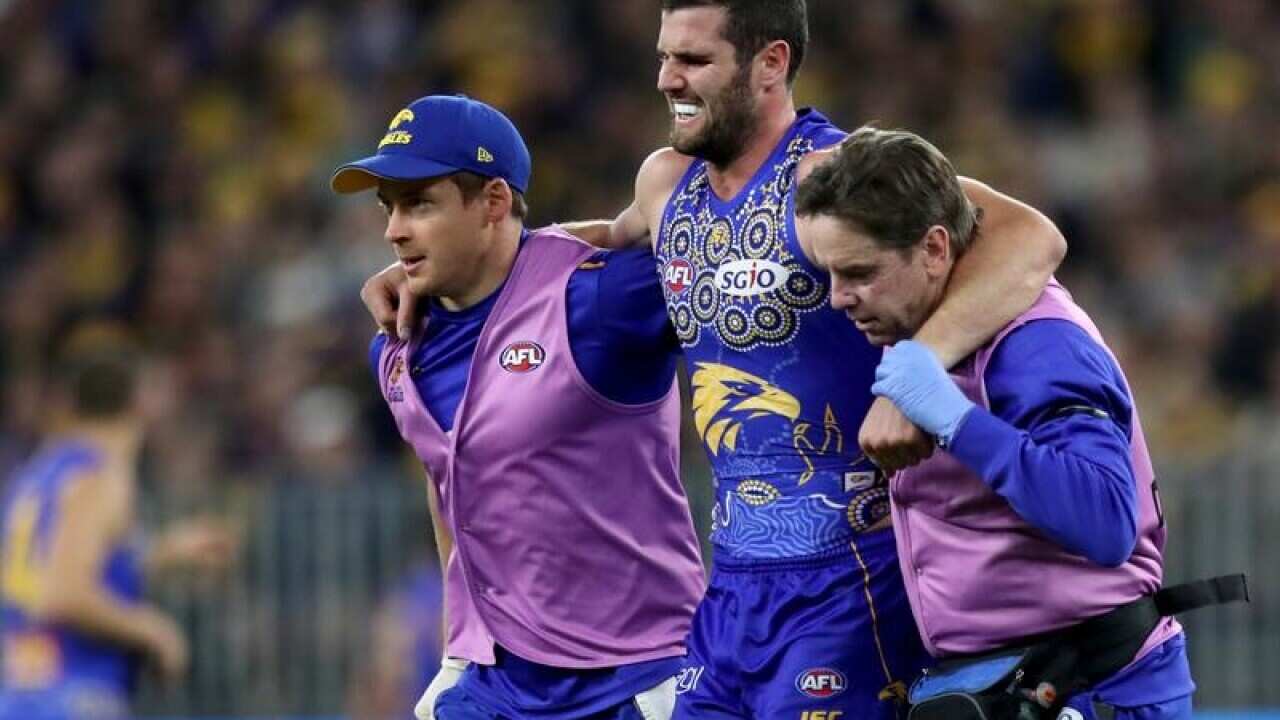 Jack Darling of the Eagles leaves the field injured.