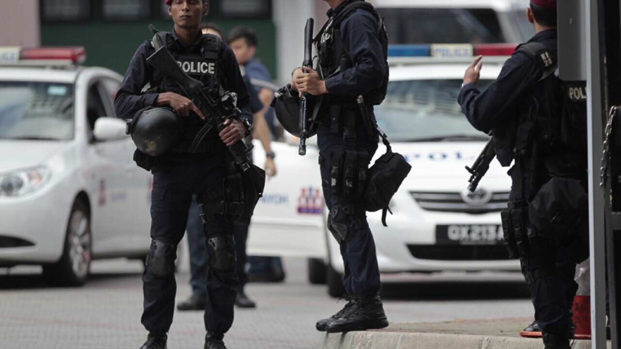 Stand guard outside the Shangri-La Hotel in Singapore