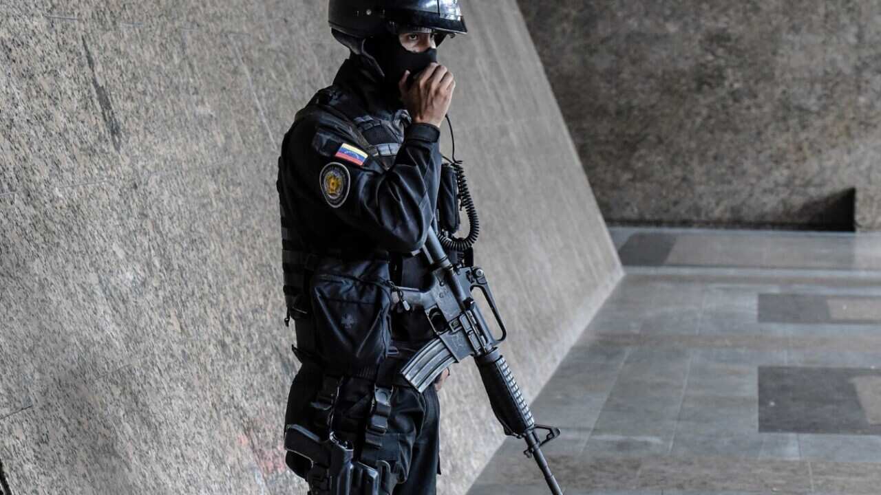 A member of the special police forces stands guard outside the Central Bank after a confrontation with a gunman