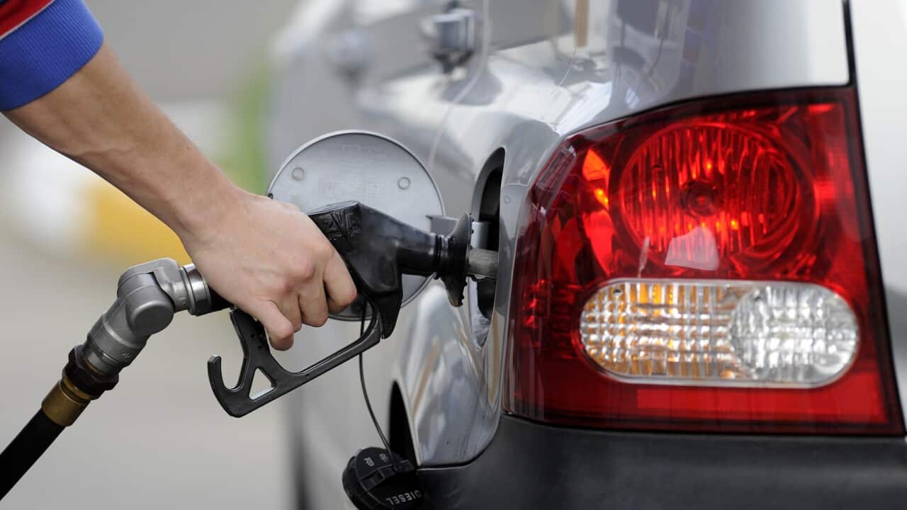 A man pumps petrol at a service station