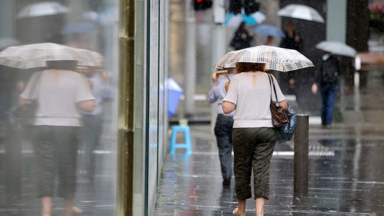 A person walking down the street with an umbrella