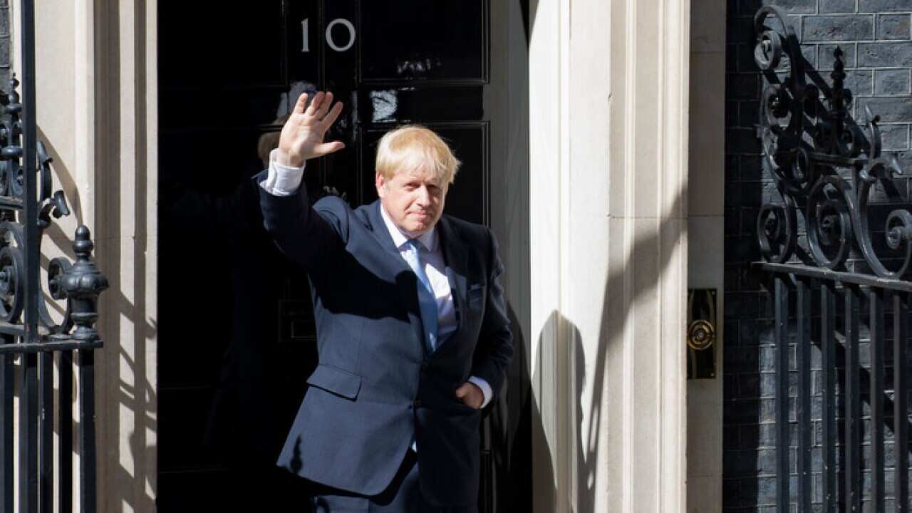 Britain's new Prime Minister Boris Johnson waves to photographers outside 10 Downing Street (AAP).